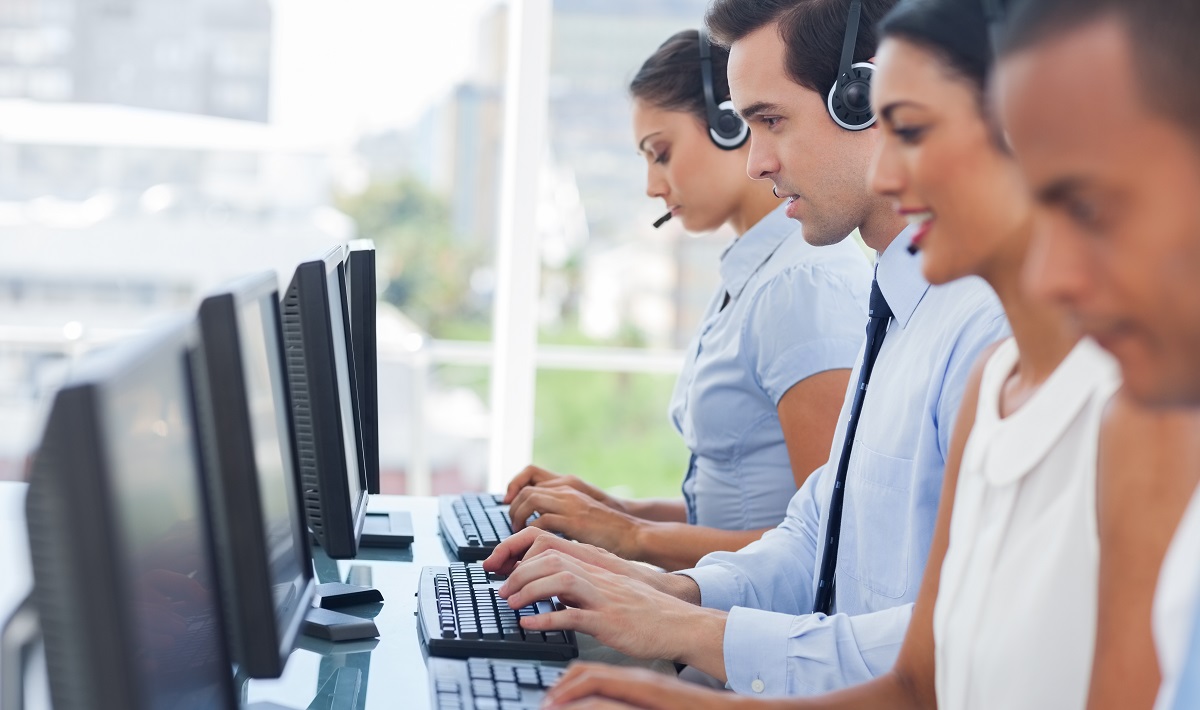 Call centre employees working on computers with their headset